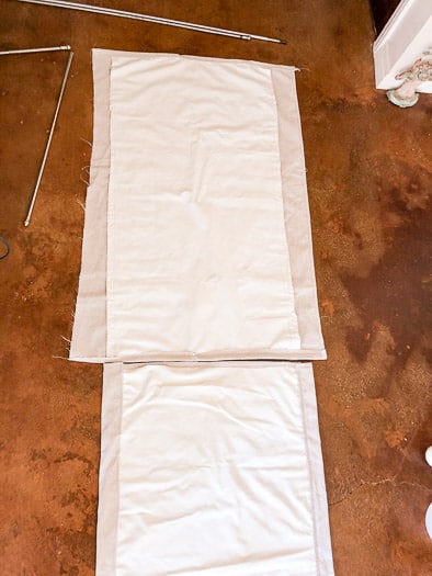 two drop cloth curtains laid out side by side