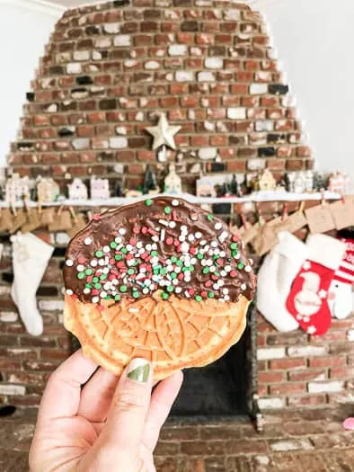 Pizzelle with half chocolate covered and red and green and white sprinkles