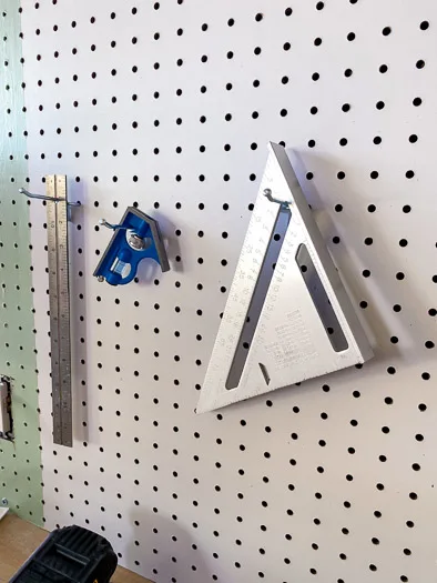 squares and rulers hung on a pegboard using single hooks from National Hardware