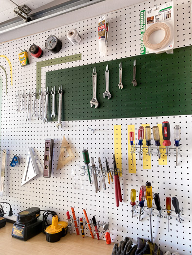 pegboard organization from National Hardware. wrenches, tape, screwdrivers and other tools hang on a pegboard