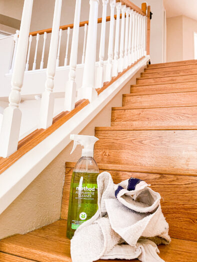 Method all purpose cleaner with towels on top of wood stairs with railings in the background