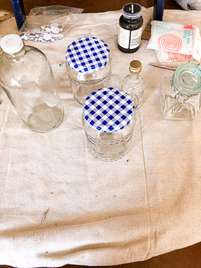 Empty jars sitting on a drop cloth