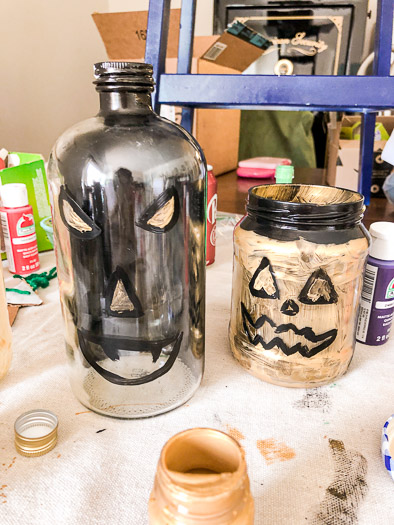 Jars painted gold with outline for eyes, nose, and mouth in black paint.