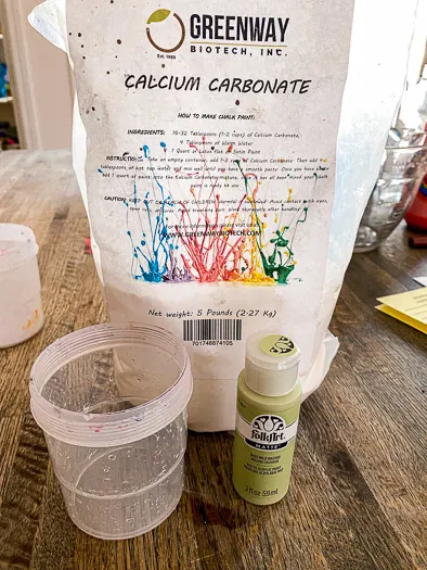 bag of calcium carbonate, 2 oz green paint bottle, and a paint cup.