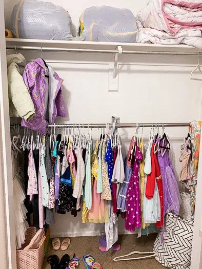 kids clothes hanging on a lower rod in a closet. The normal height rod above it.