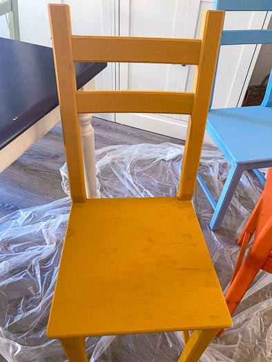 yellow chair seat after one coat showing lots of stains