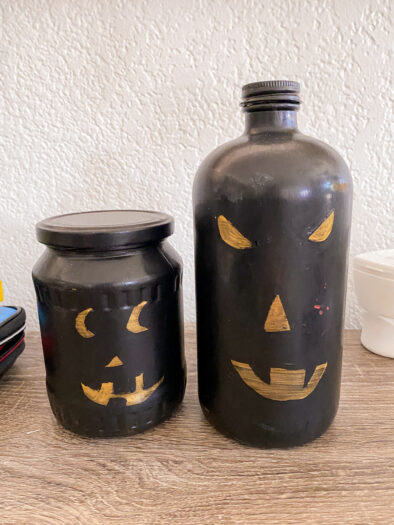 Jars painted black with gold for eyes, nose, and mouth to look like pumpkins