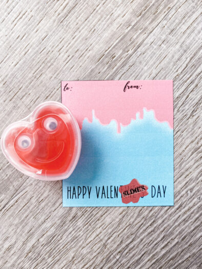 Red heart Slime next to a cardstock card that says Happy Valenslimes Day