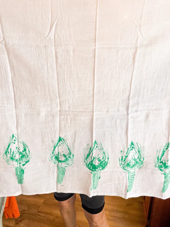 Green artichoke stamps along the bottom of a towel