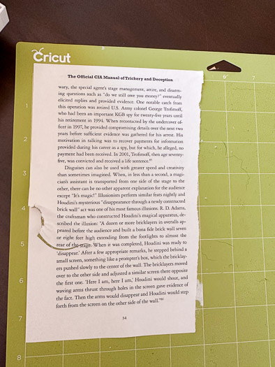 book page on a cricut mat that has been ripped