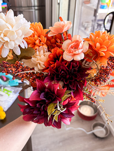 an assortment of fake flowers in orange and pink and red