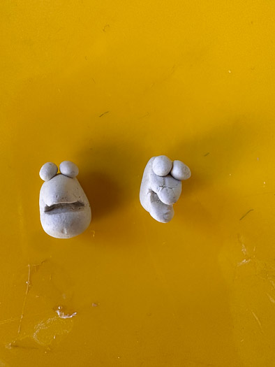 2 small monster faces out of clay