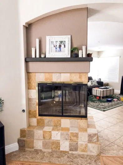 fireplace with a beige tile surround
