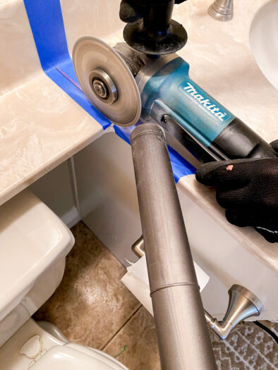 a saw spinning, being placed onto the blue tape on the counter top with a shop vac nozzle close by 