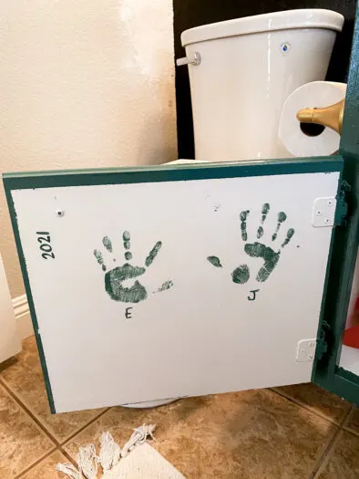 small hand prints on the inside of a cabinet