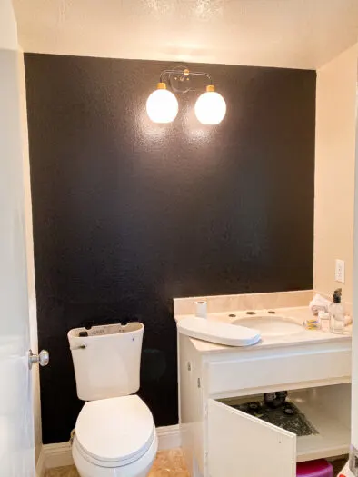 A bathroom showing the finished product with no counter top over the toilet